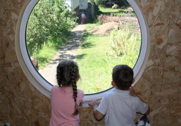 Children Looking Cabin Window