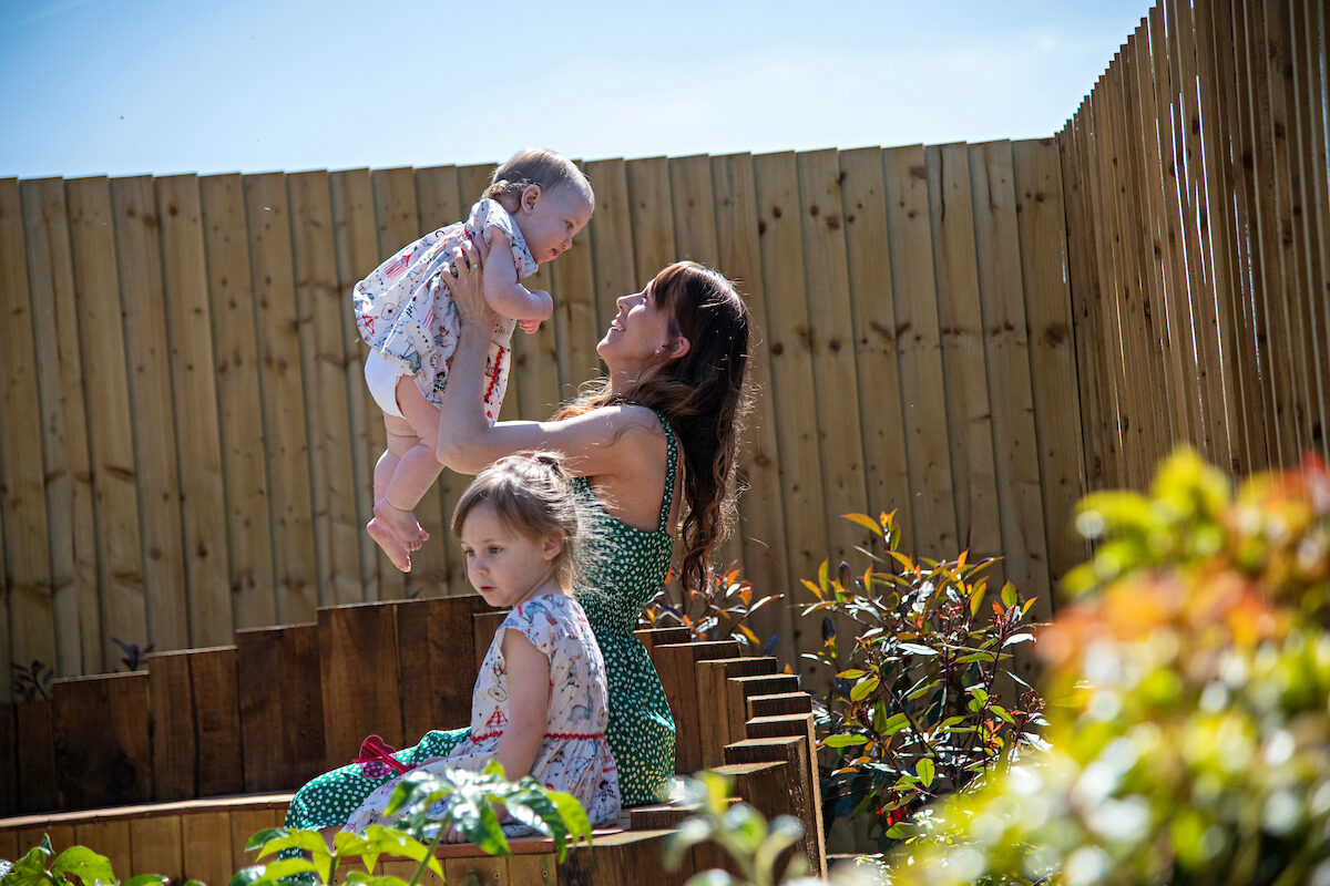 lifestyle image mother baby toddler garden